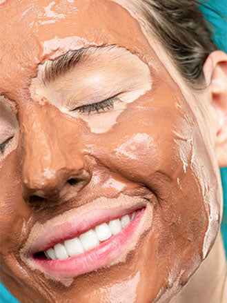 Woman with Face Mask, Homemade Facial mask with Ashwagandha and Turmeric for a quick fresh faced cleanse. 